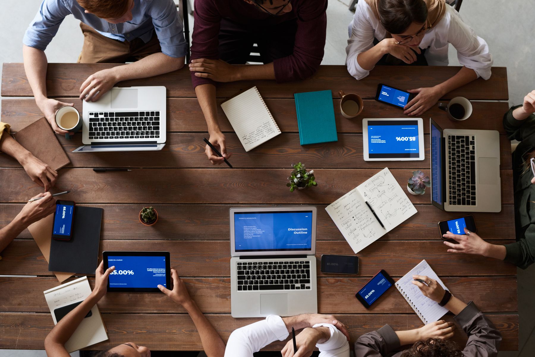 Editorial photograph of a team collaborating around a table.